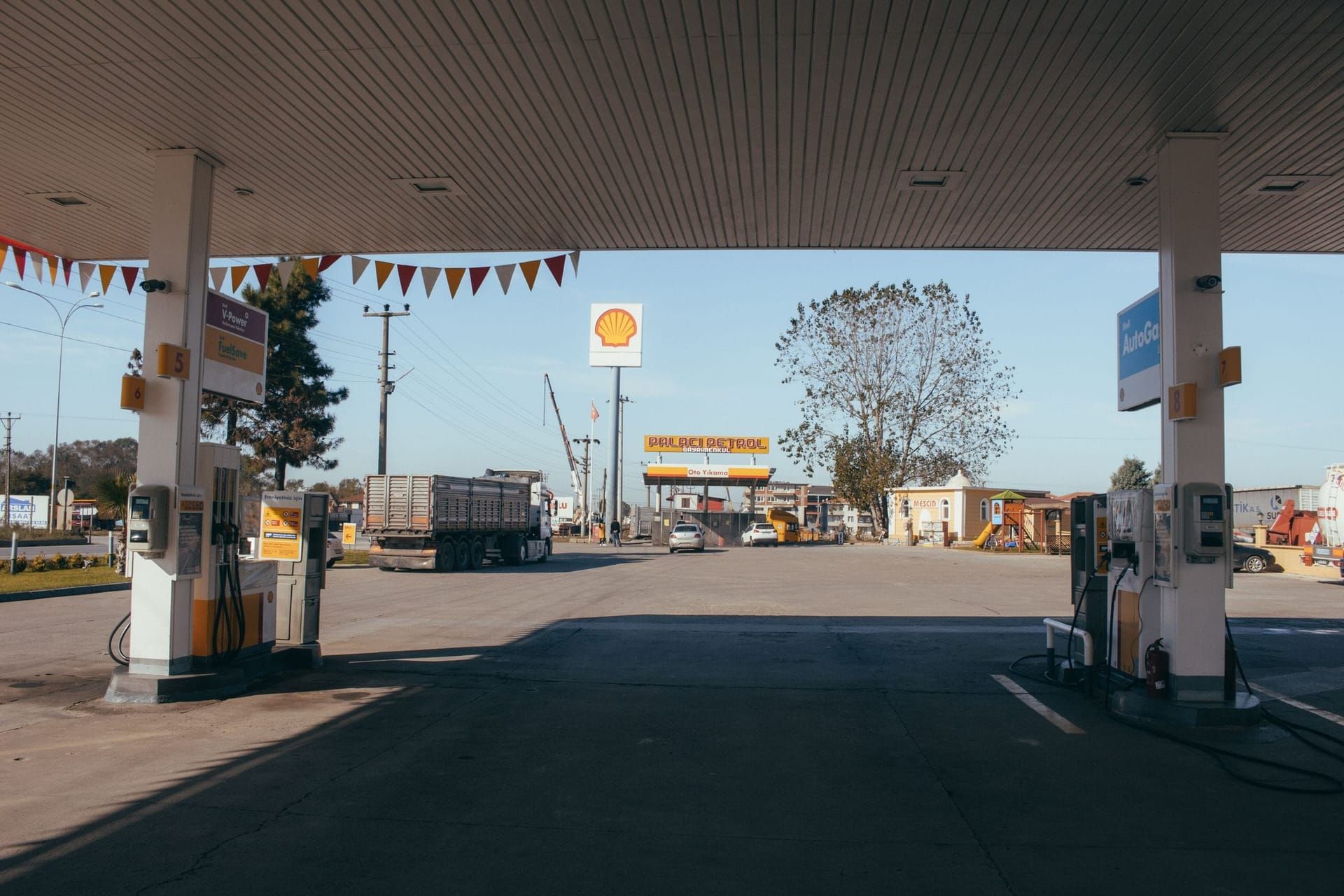 Gas station forecourt with fuel pumps under a canopy