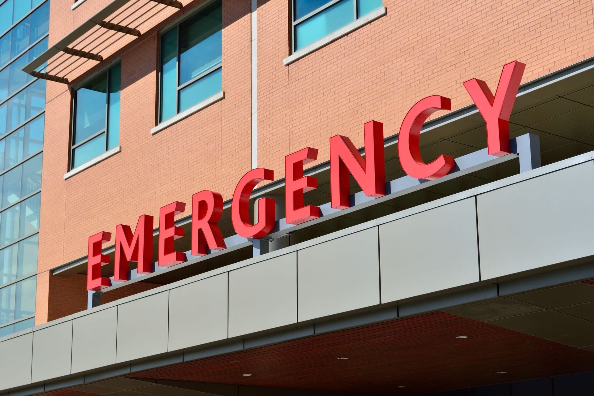 Emergency entrance sign on a brick hospital building