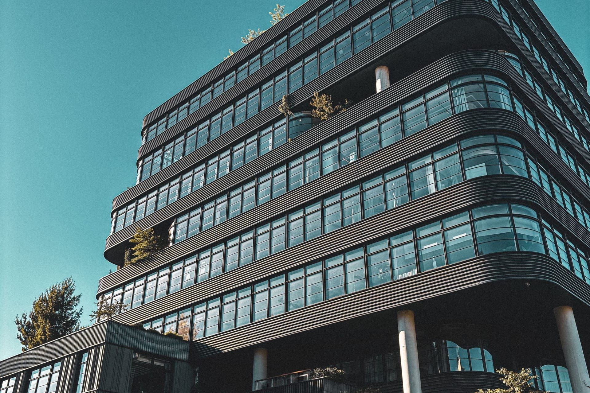 Modern multi-story office building with bands of glass windows