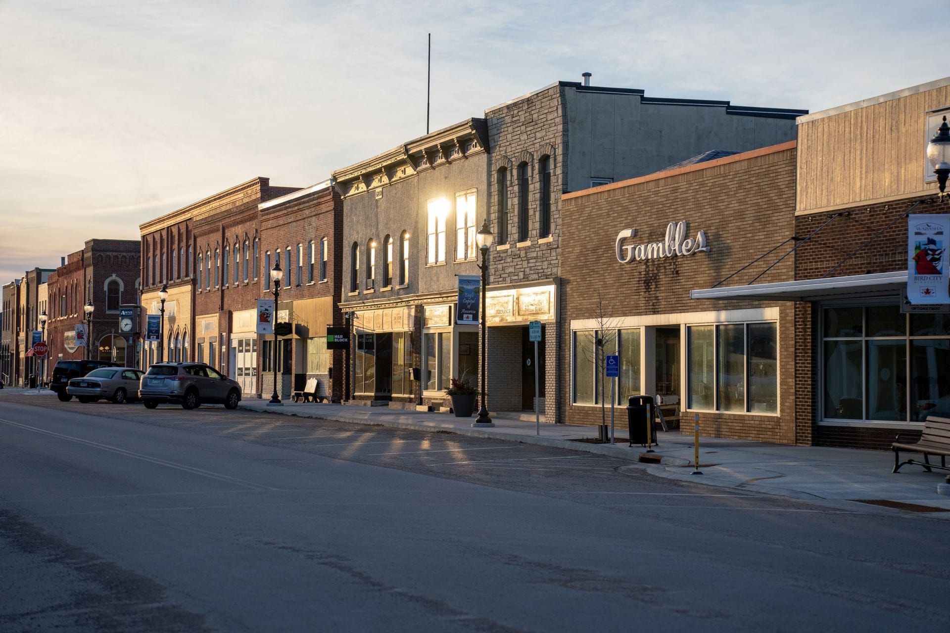 Main street of brick storefront retail buildings at sunset